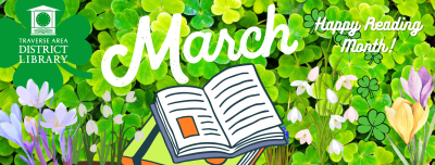 Green clovers, spring flowers, and a book with March - Happy reading month!