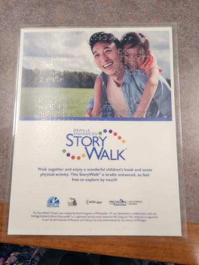 Braille Enhanced StoryWalk sign with braille overlays