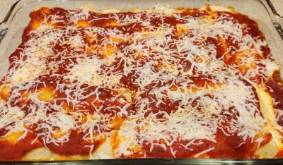 clear glass baking dish with fresh manicotti