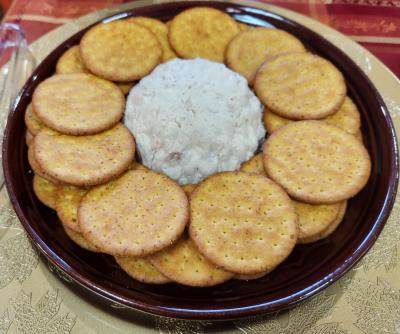 brown plate with ball of chicken pate' and crackers