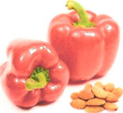 two red bell peppers, one on its side, and a small pile of almonds