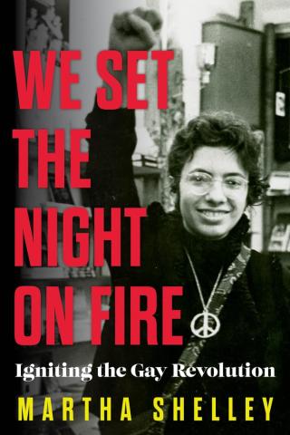 book cover for We Set the Night on Fire shows a smiling woman with her fist raised in the air in empowerment