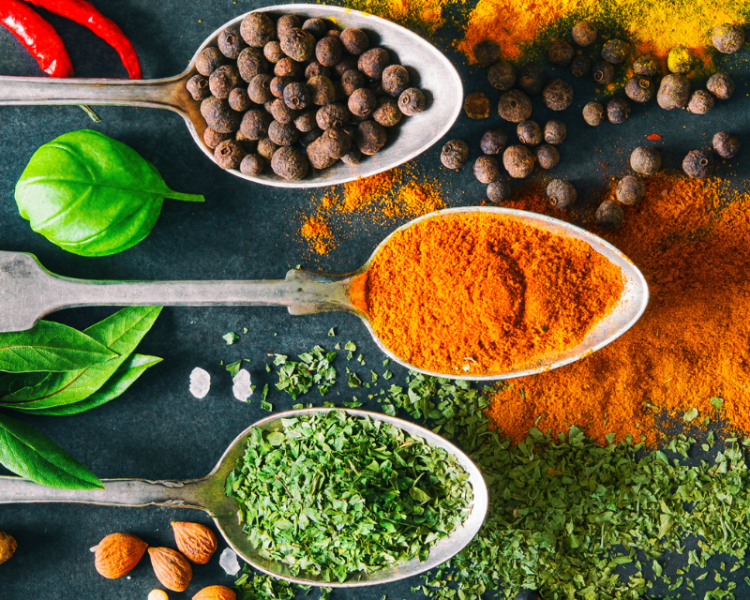 Spoons filled with colorful spices