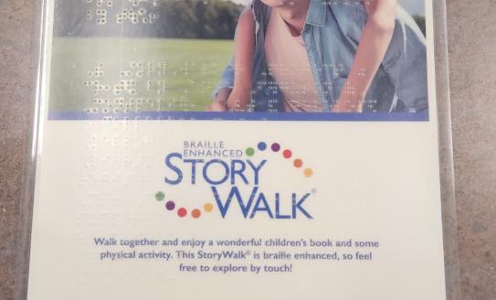 Braille Enhanced StoryWalk sign with braille overlays