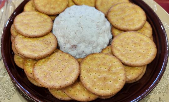 brown plate with ball of chicken pate' and crackers